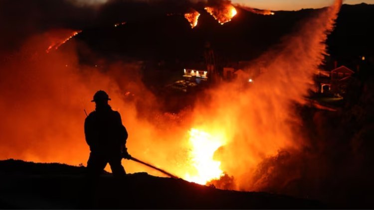 Three flames are tearing through the suburbs of Los Angeles, forcing thousands to leave their homes.